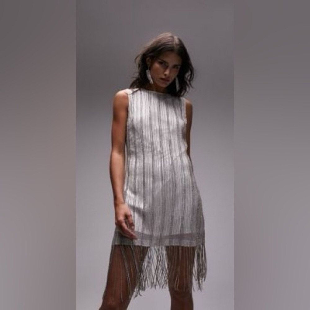Topshop white and silver with rhinestones throughout and fringe. Size 4.